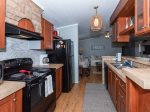The kitchen is fully equipped with a microwave, coffee maker, and dishwasher 